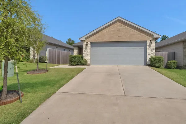a front view of house with yard and green space