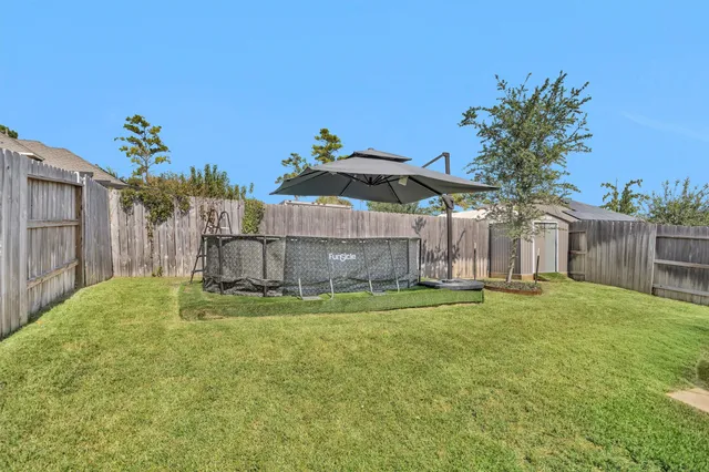 a backyard of a house with table and chairs