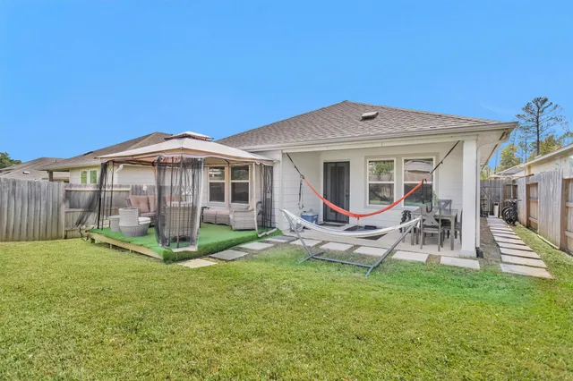 a backyard of a house with table and chairs