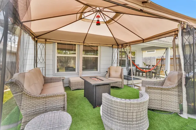 a patio area with patio furniture and garden