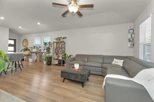 a living room with furniture and wooden floor