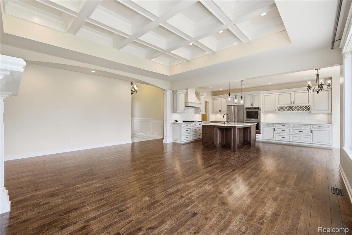 35339 West 13 Mile Road Farmington, MI 48331 - Photo 17 of 72 Great room with suspended lighting, hardwood flooring, coffered ceiling, and arched walkways