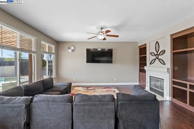 a living room with furniture a flat screen tv and a fireplace