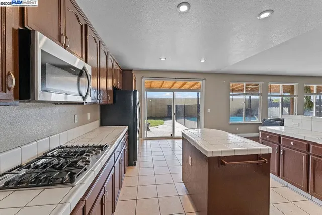 a kitchen with a stove a sink and a refrigerator