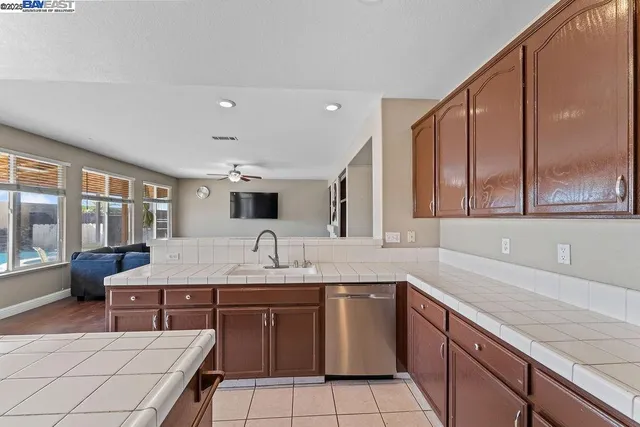 a kitchen with a sink a counter space and cabinets