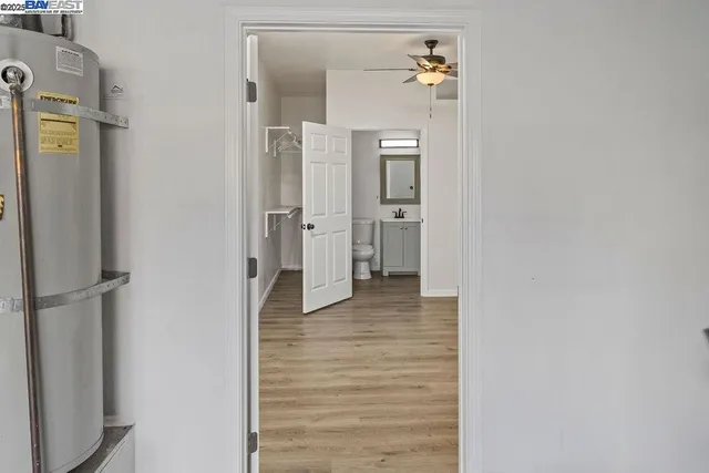 a bathroom with a sink vanity granite and toilet