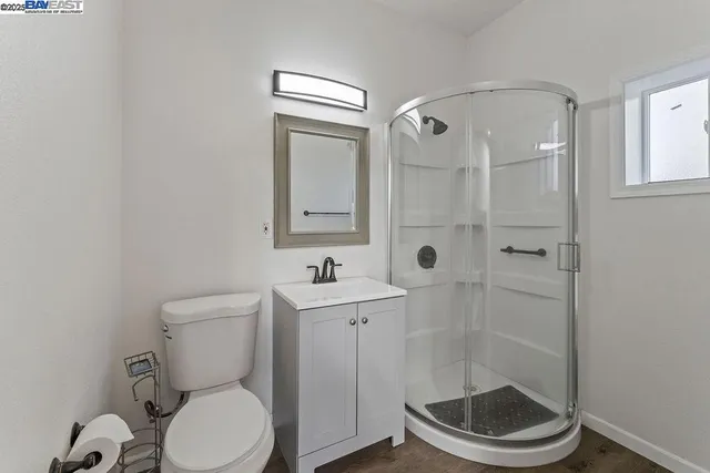 a bathroom with a double vanity sink a toilet and a bathtub