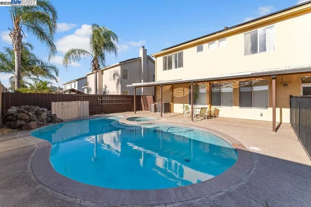 a view of a backyard with sitting area