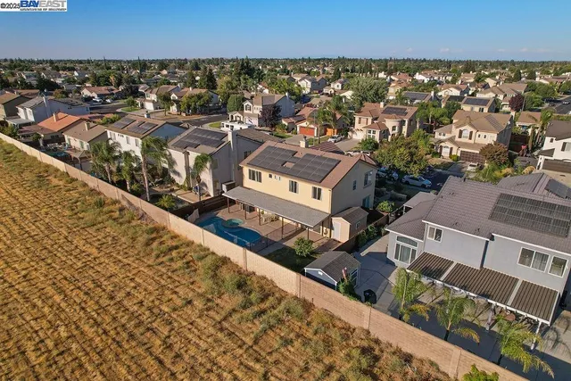 an aerial view of residential houses with outdoor space