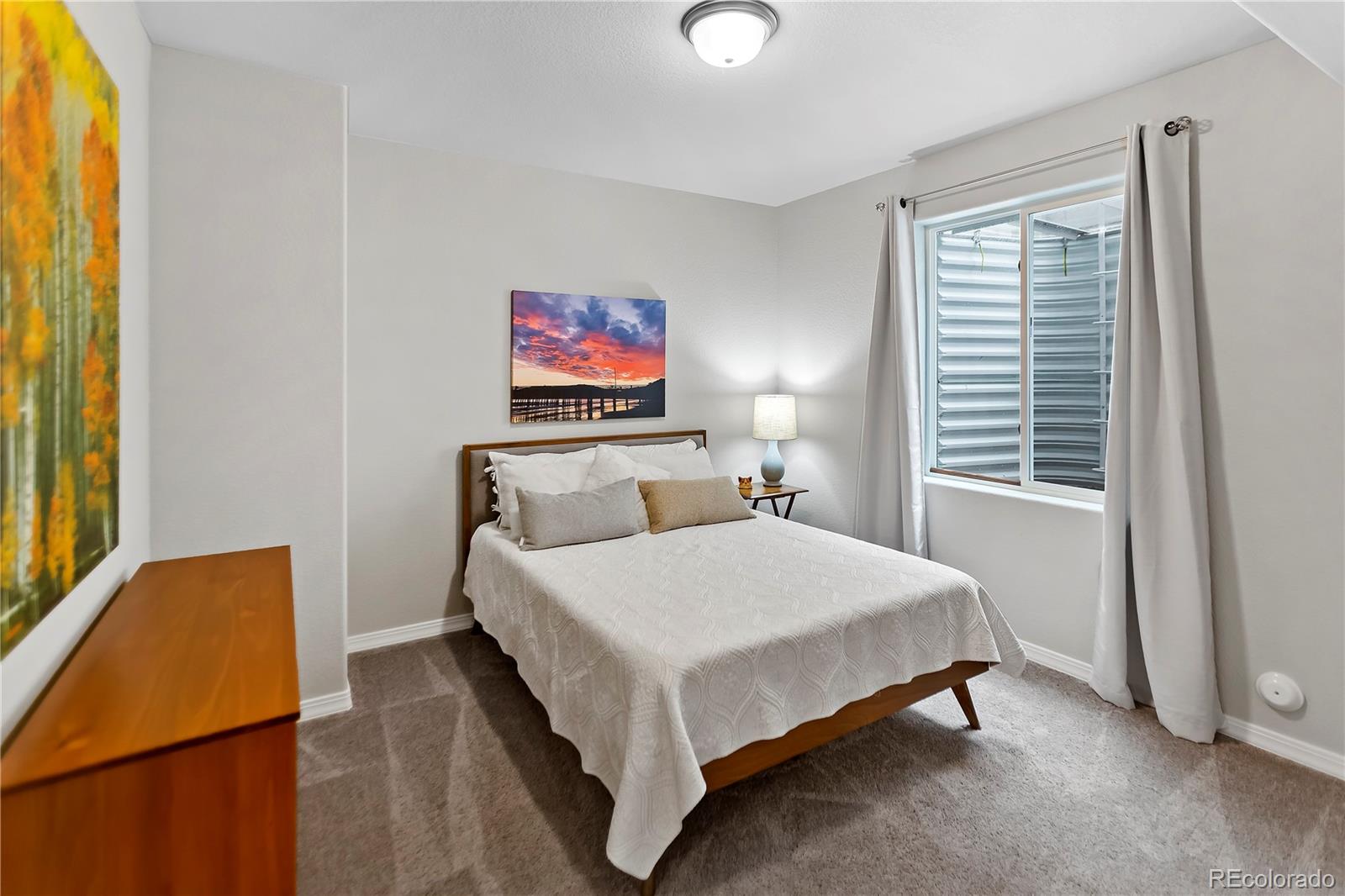 10687 Hidden Brook Circle Colorado Springs, CO 80908 - Photo 11 of 36 a bedroom with a bed and a window