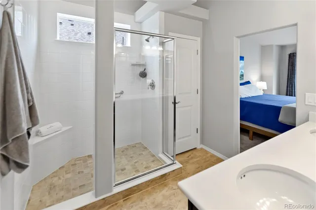 a en suite bathroom with a shower and sink