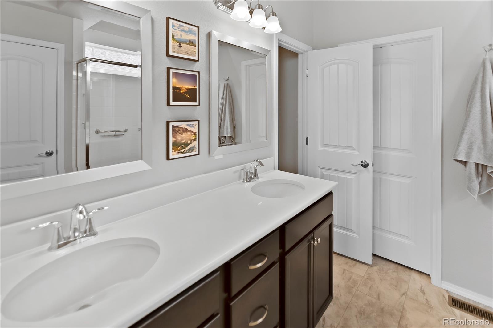 10687 Hidden Brook Circle Colorado Springs, CO 80908 - Photo 18 of 36 a bathroom with a sink and a mirror