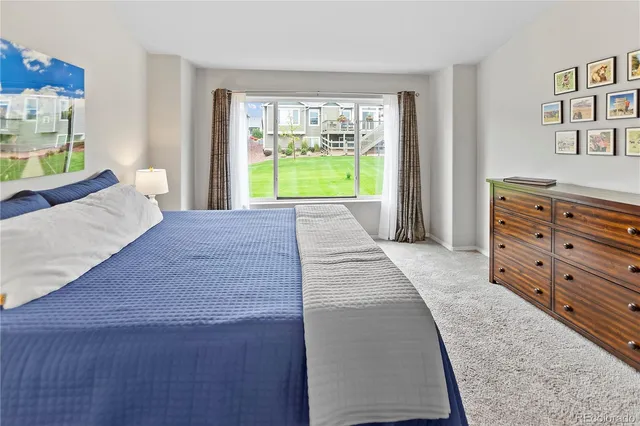 a room with a bed and a dresser