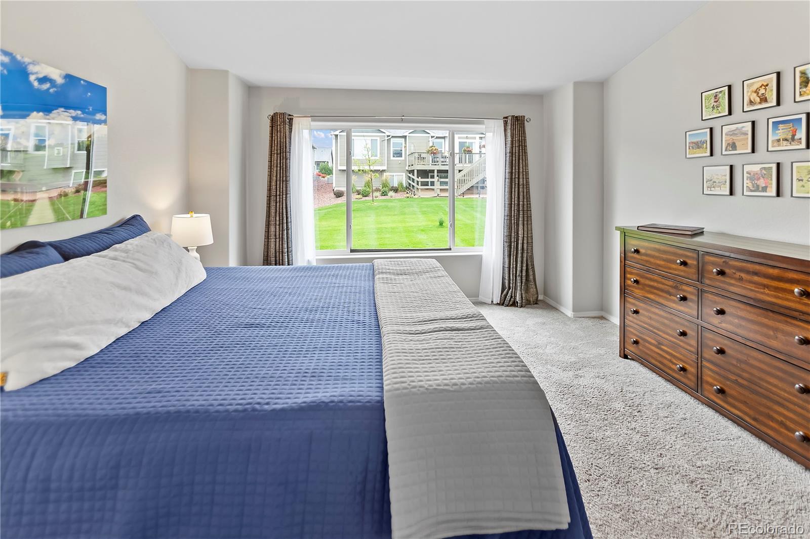 10687 Hidden Brook Circle Colorado Springs, CO 80908 - Photo 20 of 36 a room with a bed and a dresser