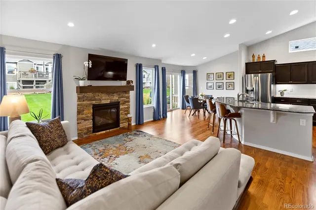 a living room with furniture fireplace and flat screen tv