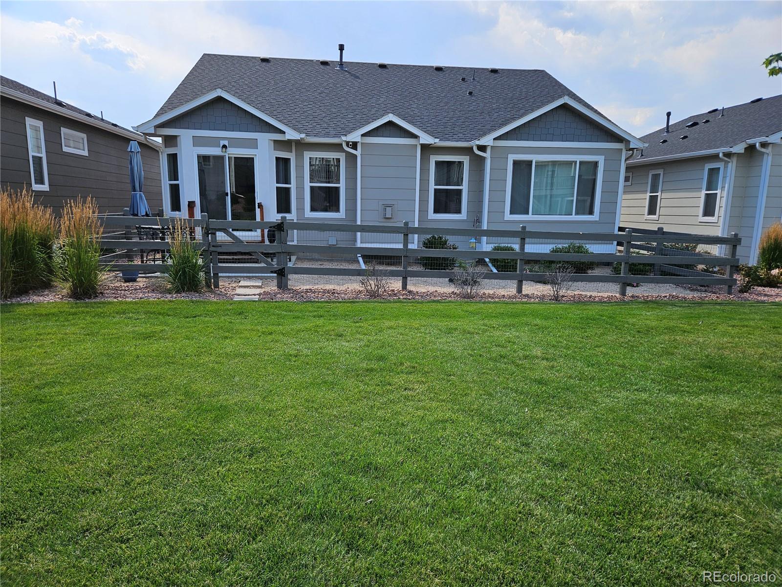 10687 Hidden Brook Circle Colorado Springs, CO 80908 - Photo 32 of 36 a front view of a house with a yard