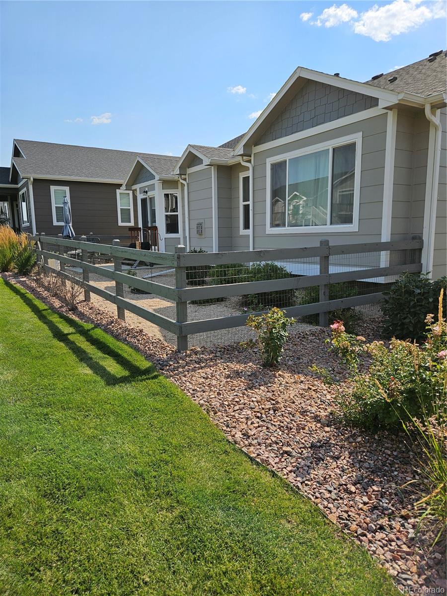 10687 Hidden Brook Circle Colorado Springs, CO 80908 - Photo 34 of 36 a front view of a house with a yard
