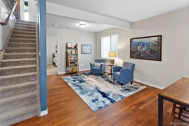 a living room with couch and wooden floor