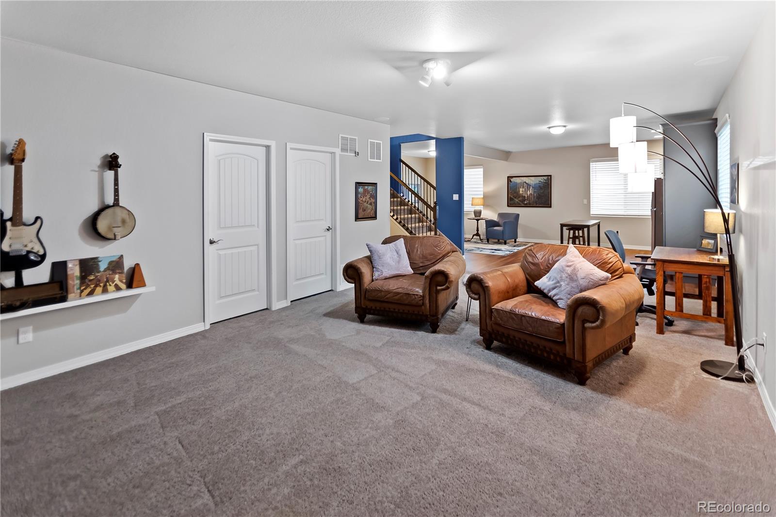 10687 Hidden Brook Circle Colorado Springs, CO 80908 - Photo 7 of 36 a living room with furniture and a gym machine