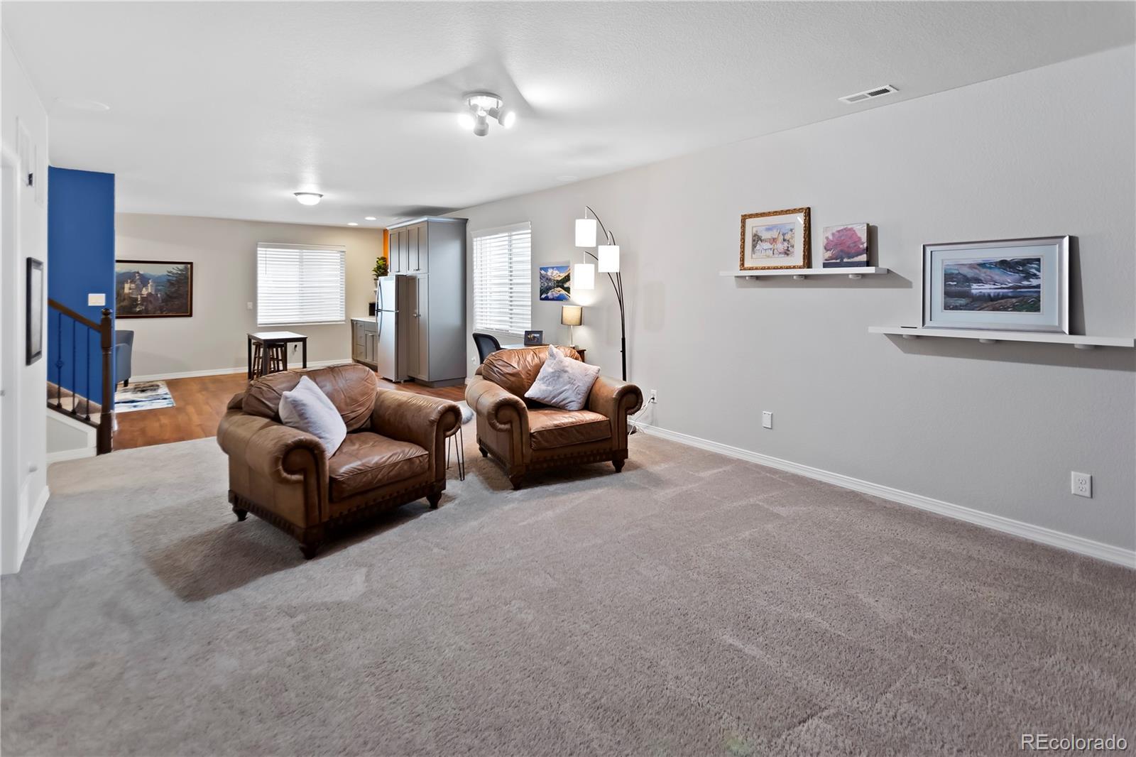 10687 Hidden Brook Circle Colorado Springs, CO 80908 - Photo 8 of 36 a living room with furniture and a window