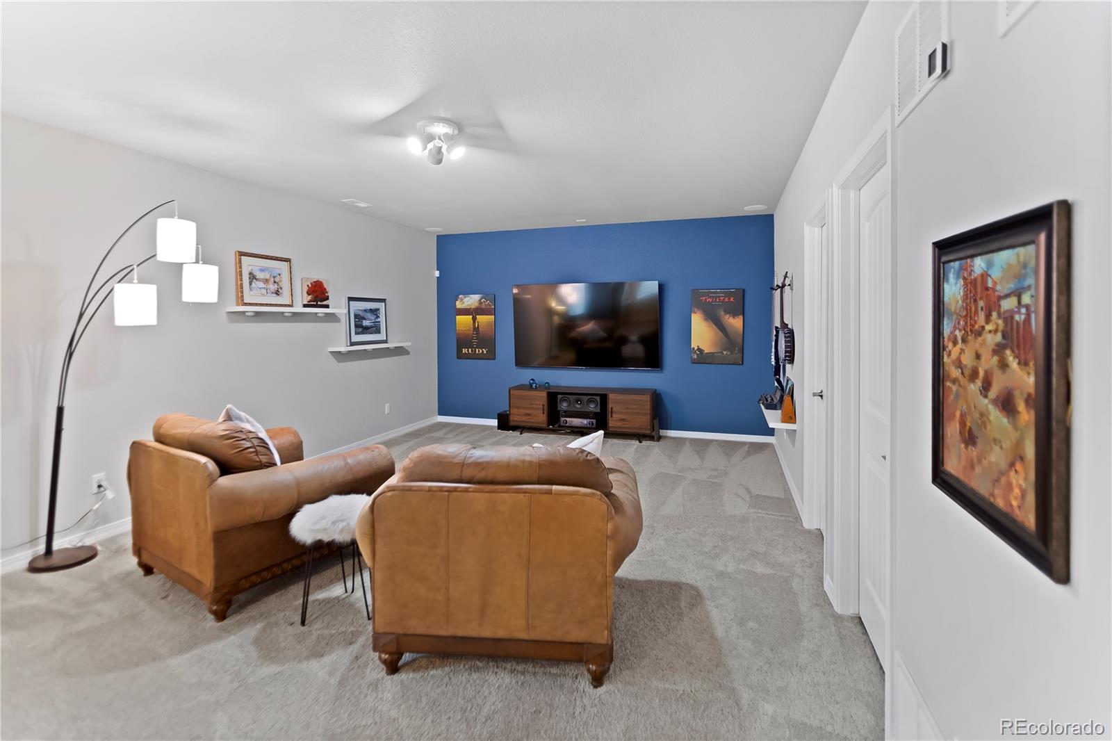 10687 Hidden Brook Circle Colorado Springs, CO 80908 - Photo 9 of 36 a living room with furniture and a flat screen tv