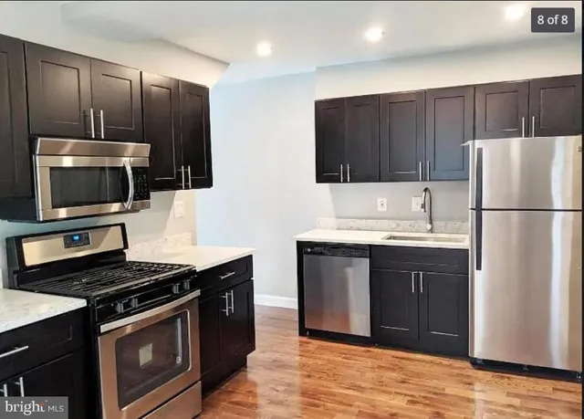 a kitchen with stainless steel appliances granite countertop a stove microwave and refrigerator