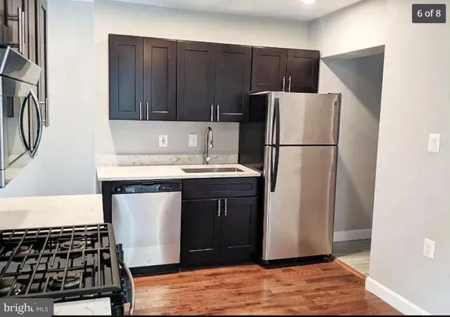 a kitchen with a refrigerator and a sink
