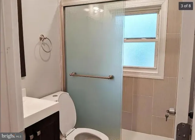 a bathroom with a toilet and a shower