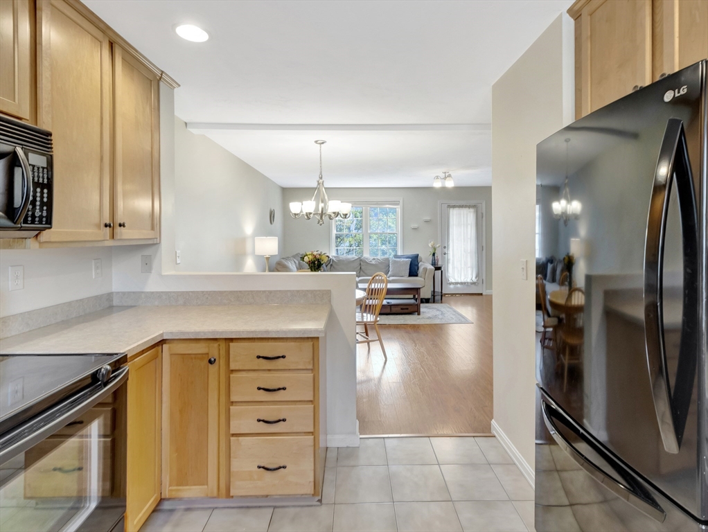 13 Shawmut Avenue, Unit 13 Mansfield, MA 02048 - Photo 11 of 34 a kitchen with a refrigerator a stove and a cabinets