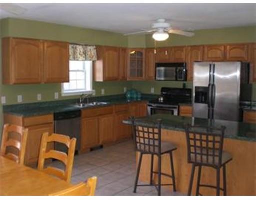 180 Corbin Road Dudley, MA 01571 - Photo 11 of 27 a kitchen with granite countertop a sink cabinets and stainless steel appliances