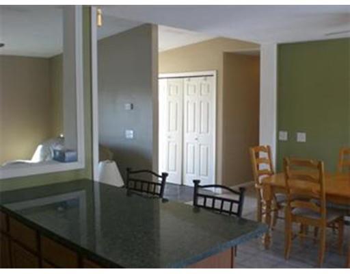 180 Corbin Road Dudley, MA 01571 - Photo 13 of 27 a room with a table chairs and bedroom view