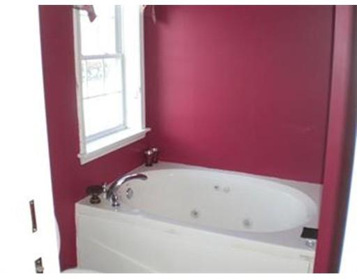 180 Corbin Road Dudley, MA 01571 - Photo 21 of 27 a white bath tub sitting in a bathroom next to a window
