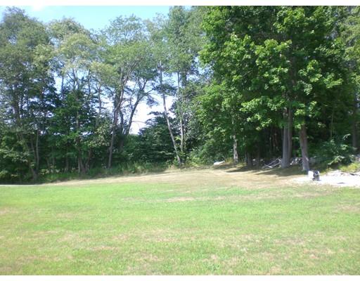 180 Corbin Road Dudley, MA 01571 - Photo 10 of 27 a backyard of a house with a yard and trees