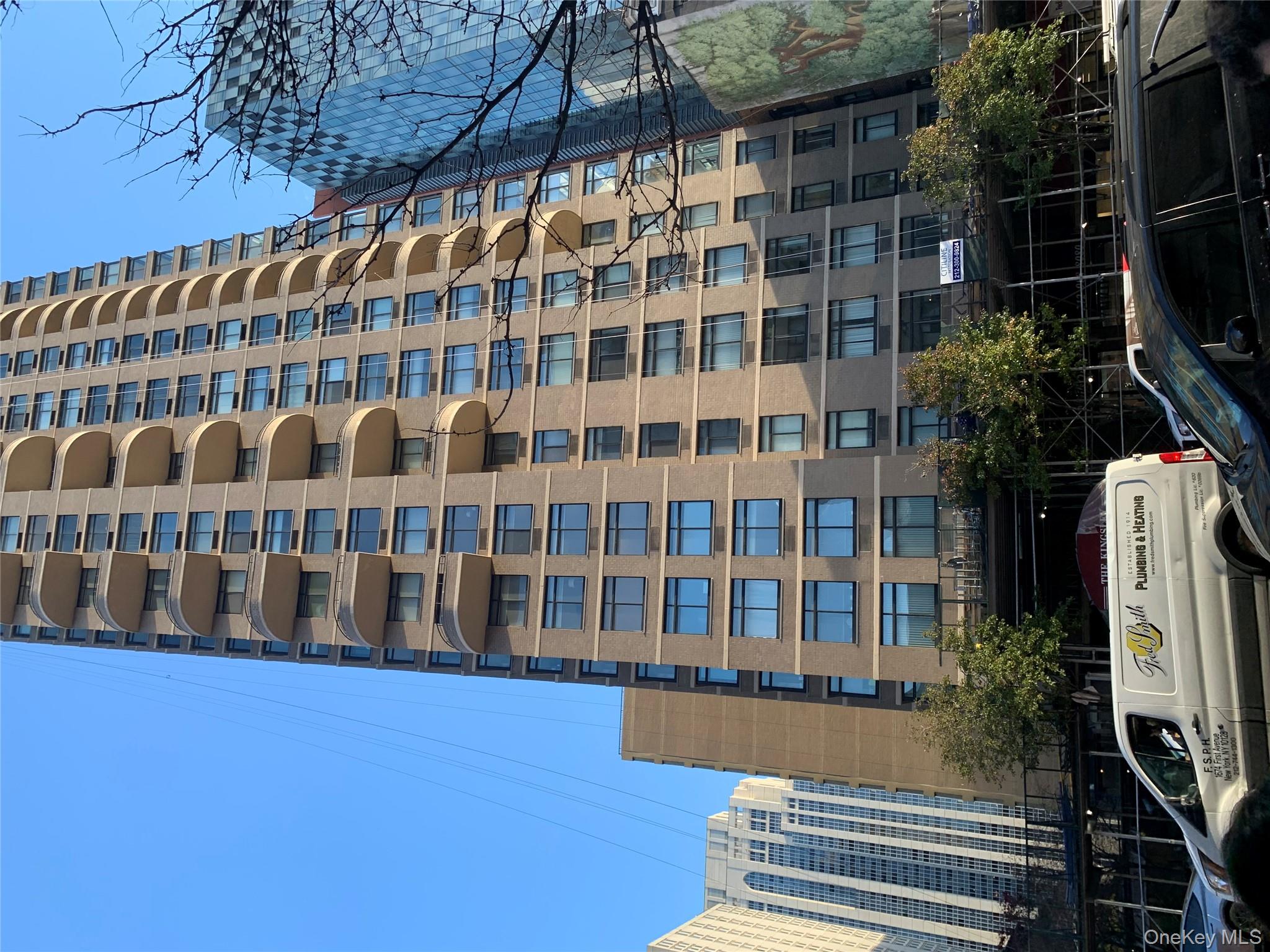 a front view of a building with parking space