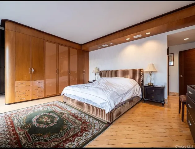 a bedroom with a bed and wooden floor