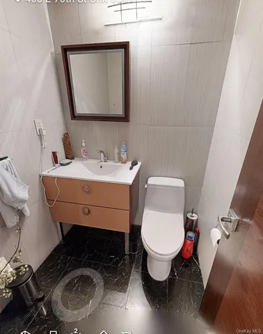 a bathroom with a toilet sink and mirror