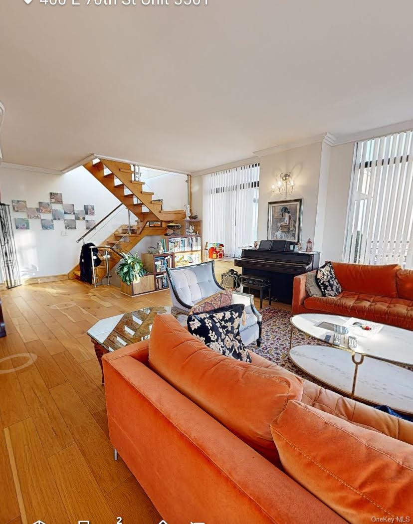 400 East 70th Street, Unit 3501 Manhattan, NY 10021 - Photo 15 of 21 a living room with furniture and a fireplace