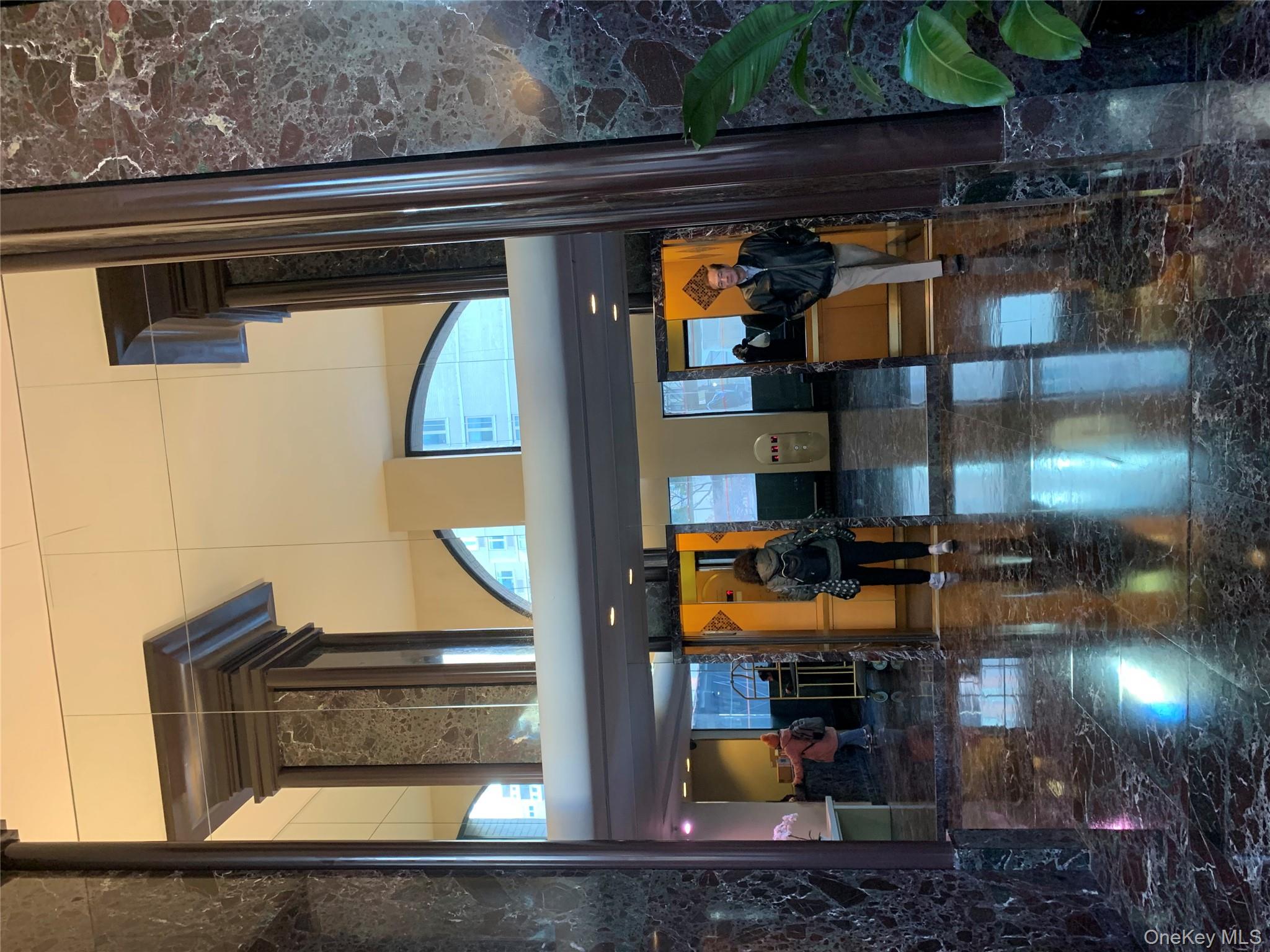 400 East 70th Street, Unit 3501 Manhattan, NY 10021 - Photo 16 of 19 Lobby featuring a high ceiling