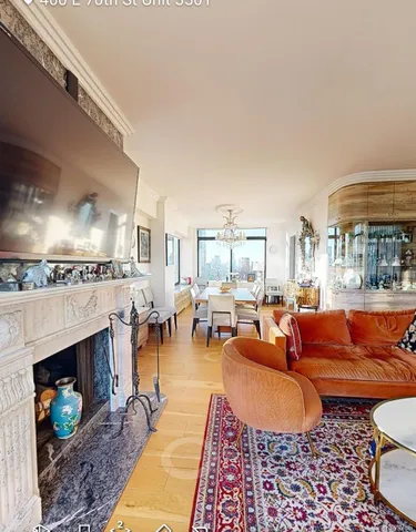 a living room with furniture a fireplace and a dining table with rug