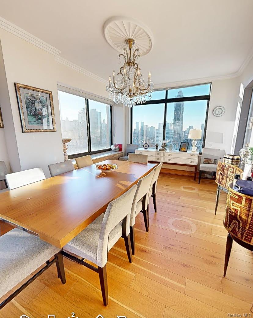 400 East 70th Street, Unit 3501 Manhattan, NY 10021 - Photo 20 of 21 a view of a dining room with furniture window and wooden floor