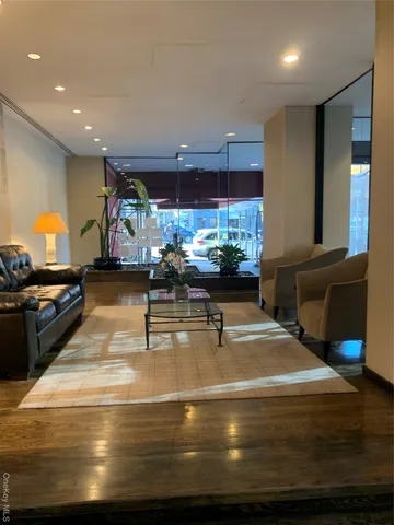 a living room with kitchen view and a couch