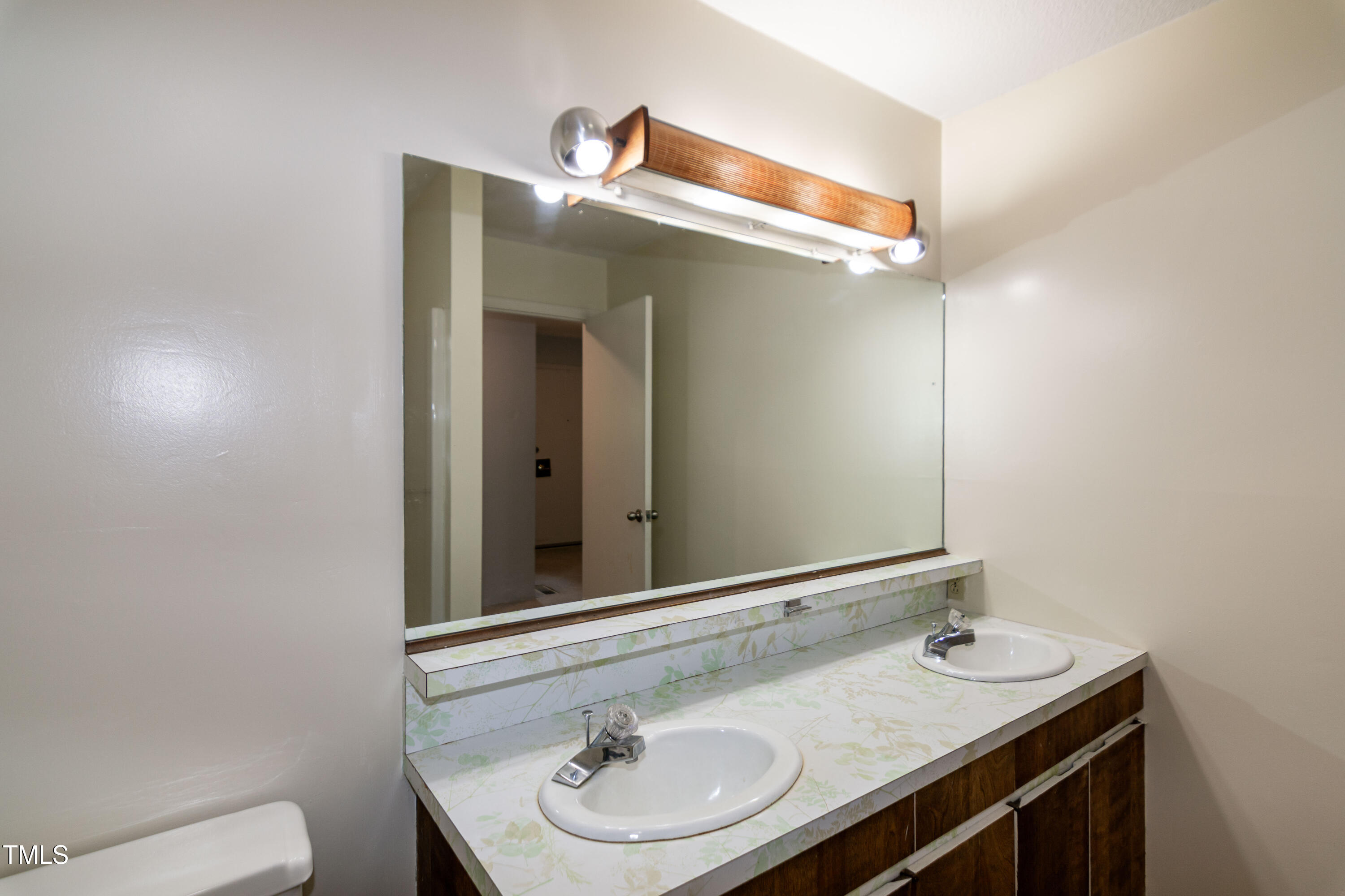 5213 Tomahawk Trail Raleigh, NC 27610 - Photo 29 of 80 a bathroom with a sink and a mirror