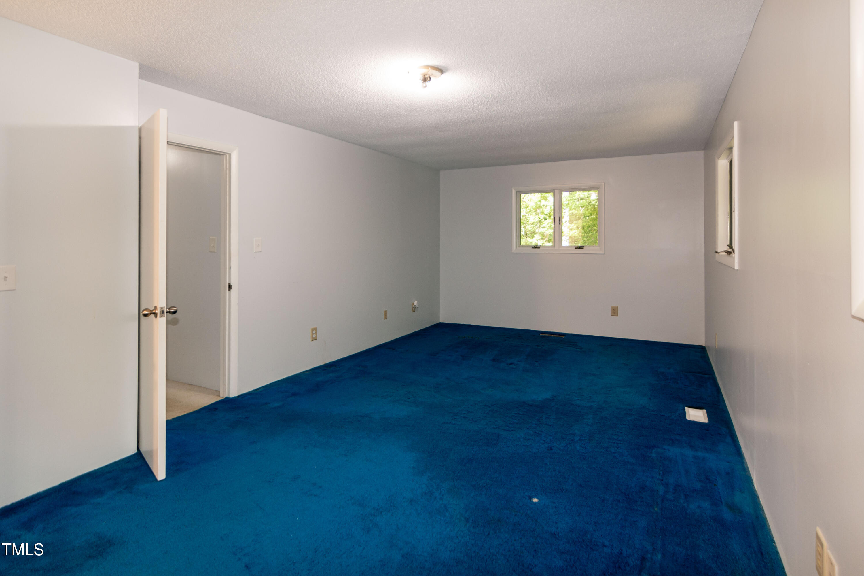 5213 Tomahawk Trail Raleigh, NC 27610 - Photo 39 of 80 an empty room with wooden floor and windows
