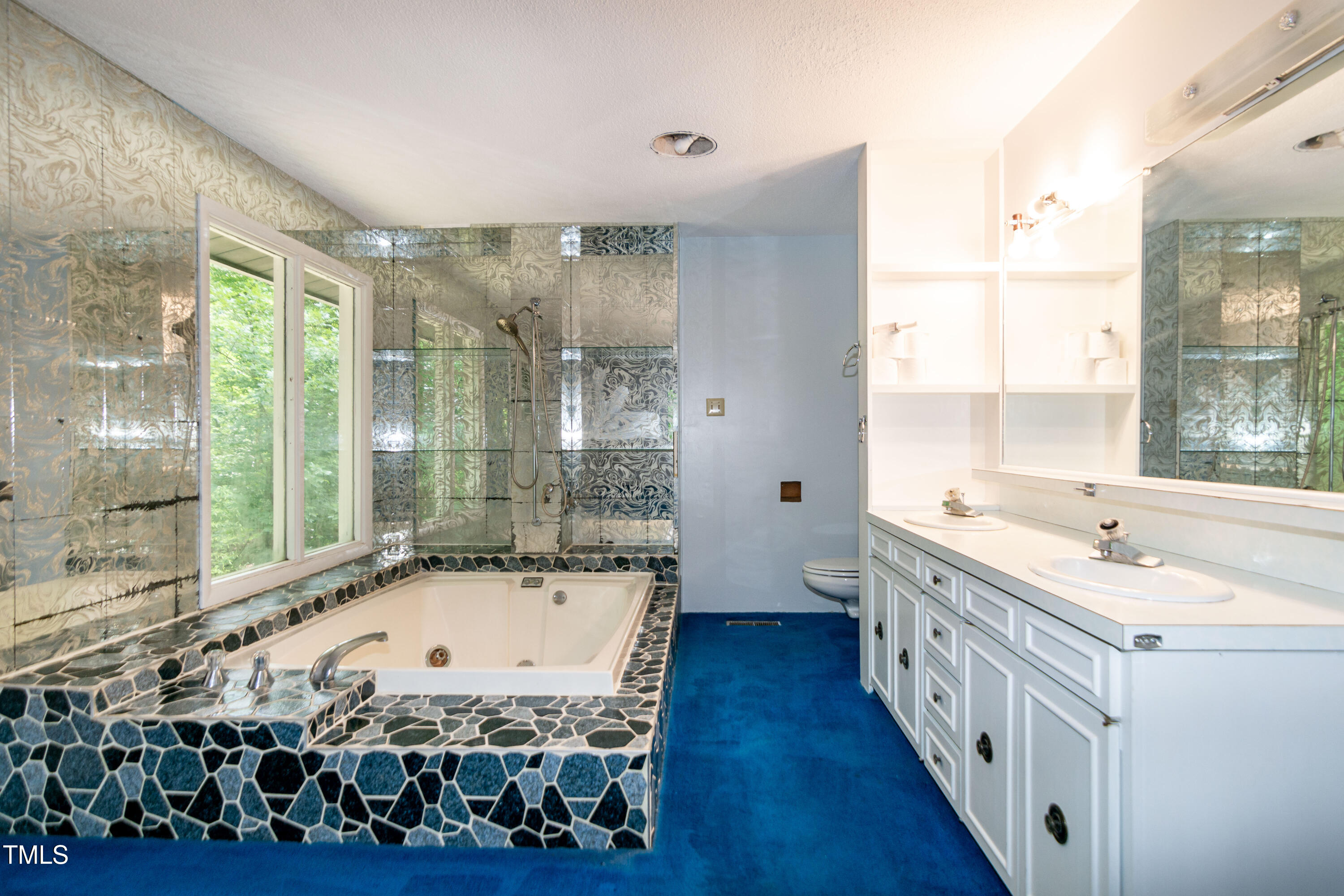 5213 Tomahawk Trail Raleigh, NC 27610 - Photo 40 of 80 a bathroom with a tub a sink and a large window