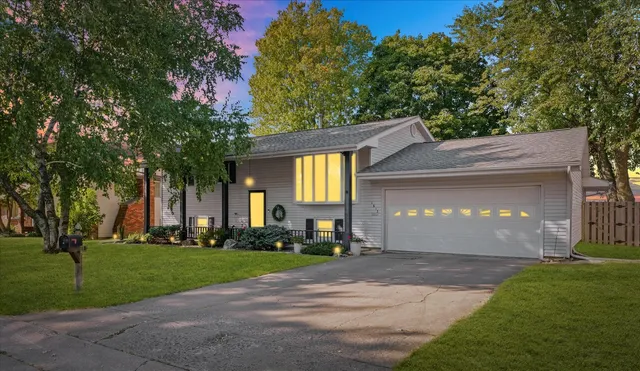 a front view of a house with a garden and yard