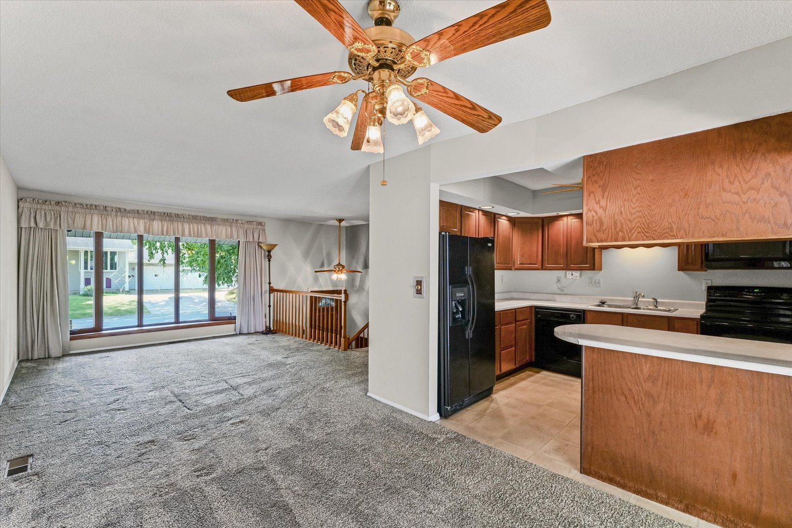1613 Carolina Drive Rantoul, IL 61866 - Photo 13 of 50 a kitchen with stainless steel appliances granite countertop a stove a refrigerator a sink a oven with a dining table and chairs