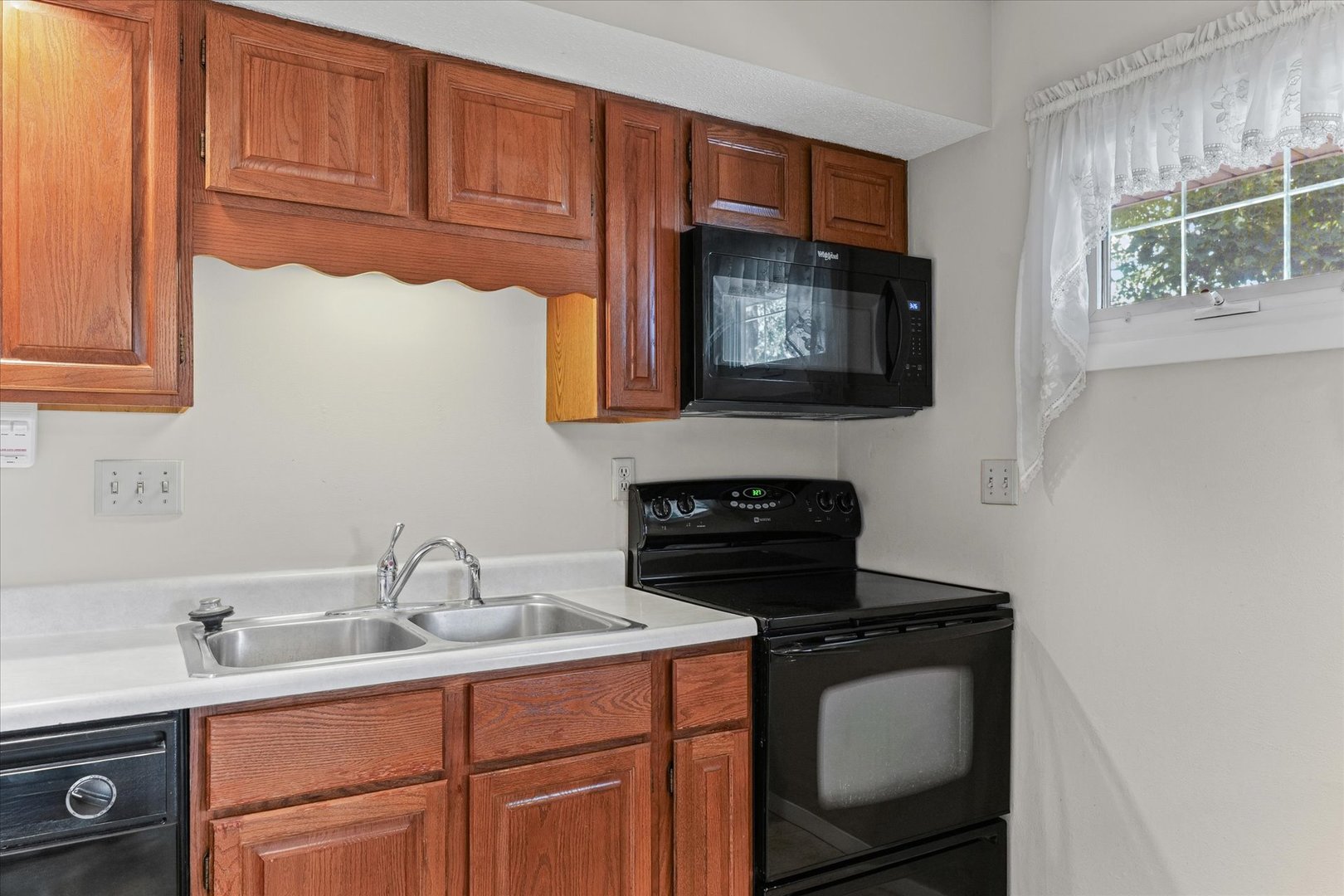 1613 Carolina Drive Rantoul, IL 61866 - Photo 16 of 50 a kitchen with stainless steel appliances granite countertop a sink stove and microwave