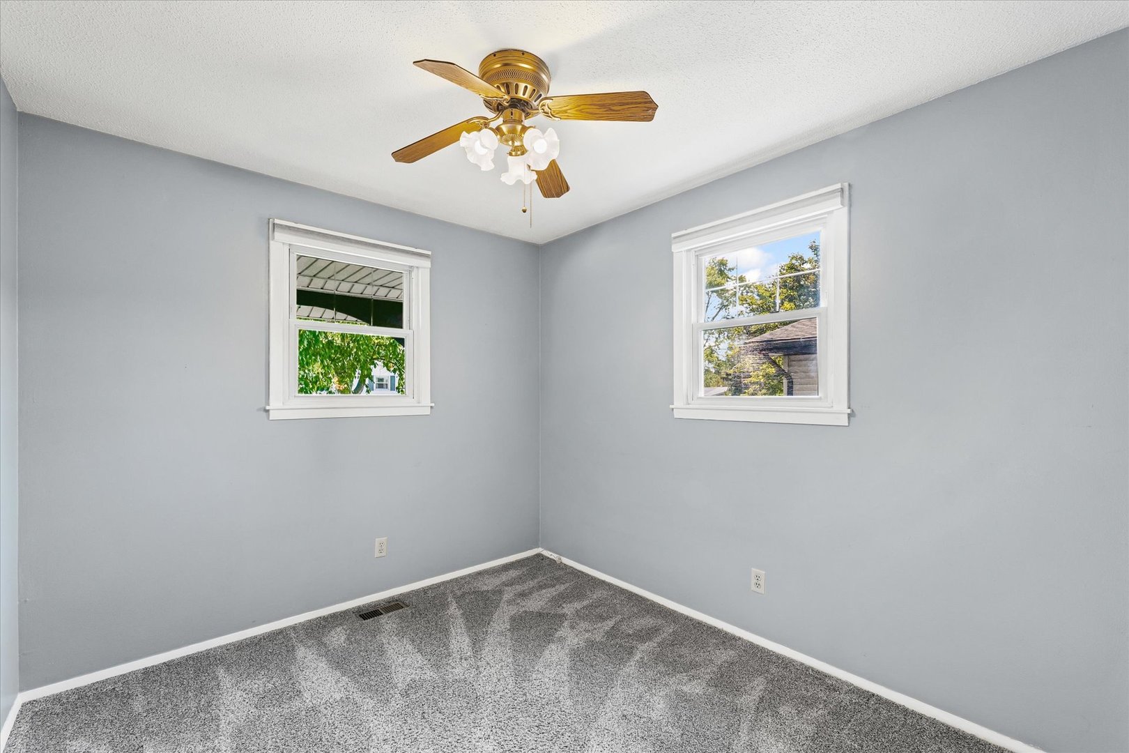 1613 Carolina Drive Rantoul, IL 61866 - Photo 22 of 50 an empty room with a window and a ceiling fan