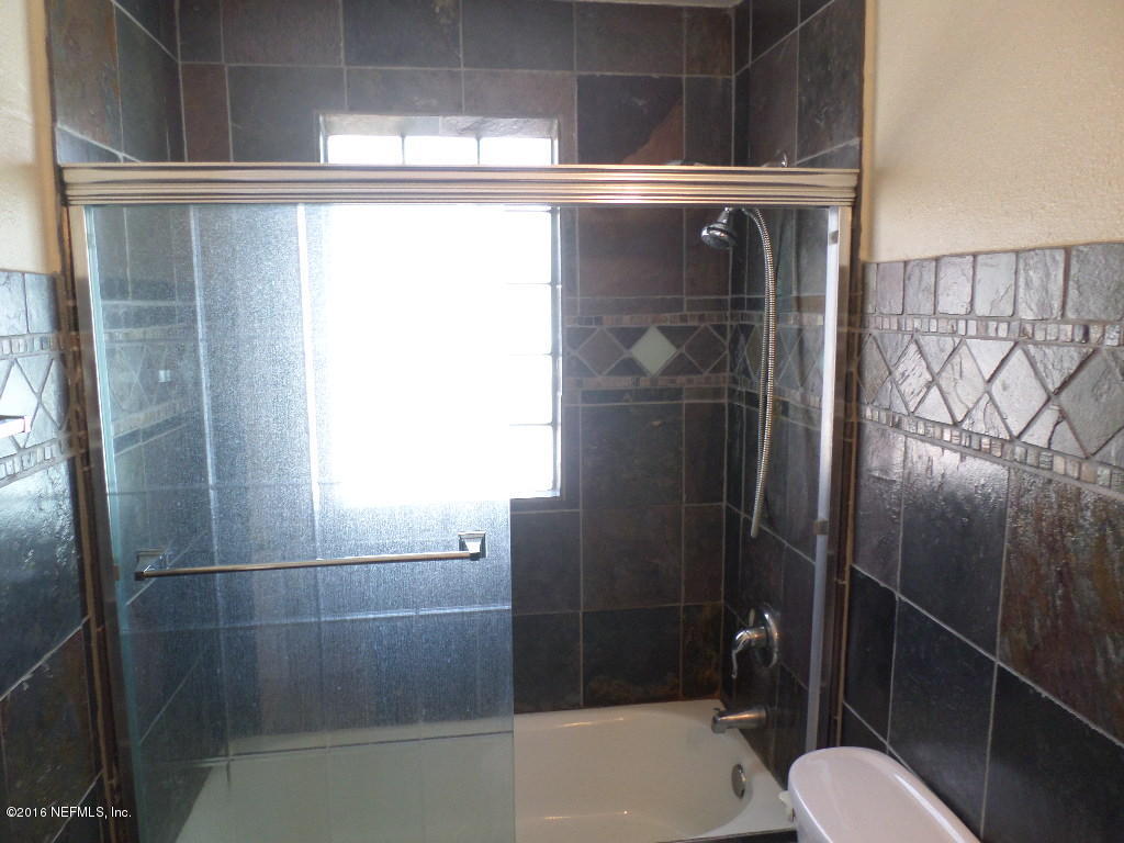 4237 Stacey Road Jacksonville, FL 32250 - Photo 11 of 22 a bathroom with a shower and toilet