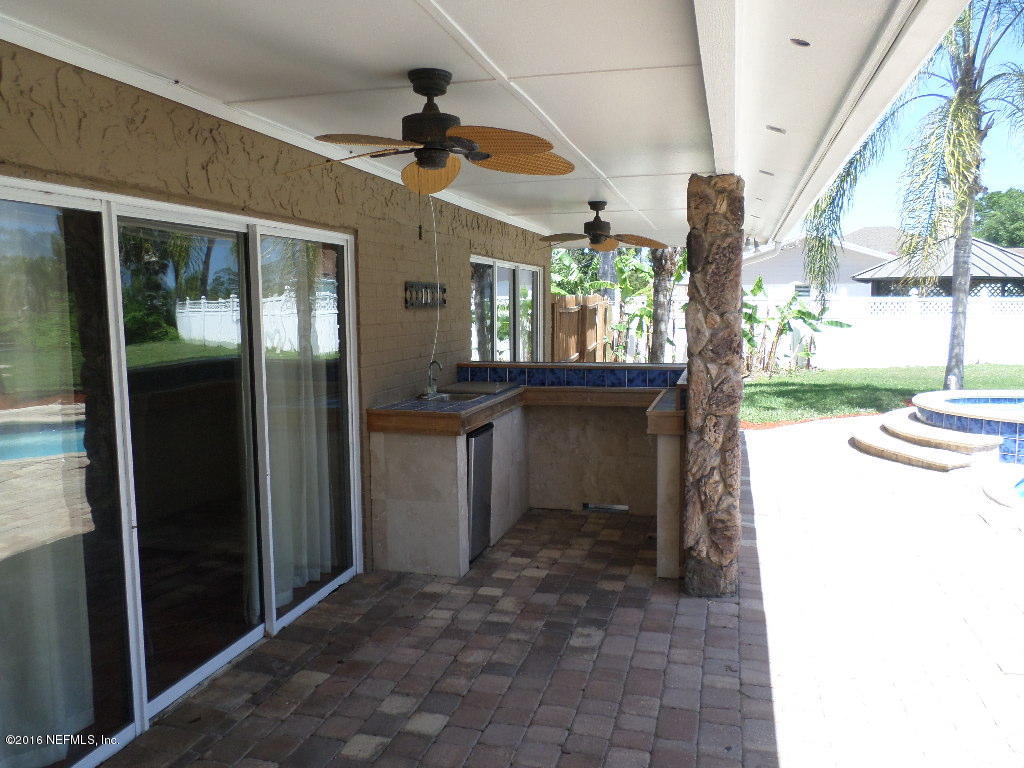 4237 Stacey Road Jacksonville, FL 32250 - Photo 15 of 22 a view of a porch with a table and chairs